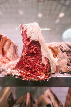 Raw beef steak on a chiller at a butcher's shop for maturing
