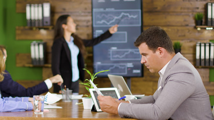 Businessman working in the conference room holding charts