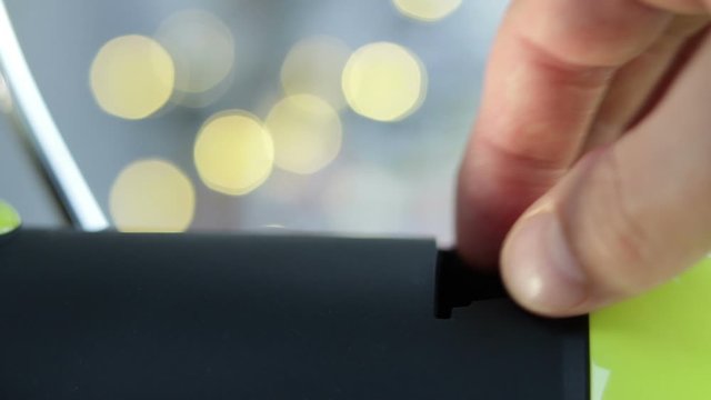 White Male Hand Putting Coffee Pod Capsule Into Espresso Coffee Machine And Closing Handle Bokeh Light Background