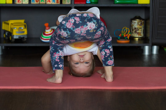 Little Girl Bending Down Making Physical Training Indoor