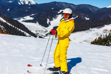 Fototapeta na wymiar Attractive woman with ski over winter background