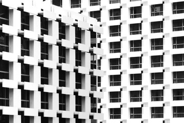 beautiful light and shadow on windows and building balconies of the vintage hotel at the summertime. black and white photo of architecture design.