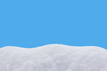 Fototapeta na wymiar snowdrift isolated on blue background close-up