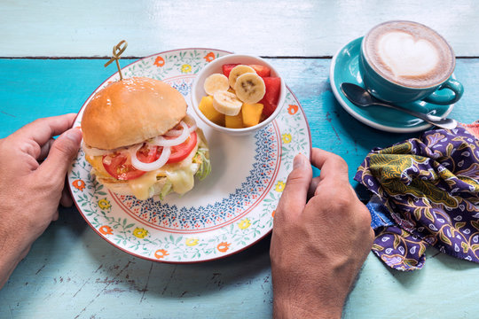 Man's hands holding ovo lacto vegetarian meal
