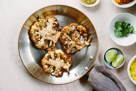 Indian spiced cauliflower steaks with rice, daal and condiments.