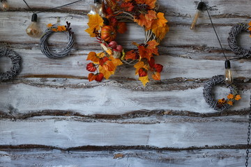 Decorative wreath, autumn theme with leaves and pumpkins, in honor of Halloween.