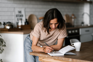 Young artist sketching in kitchen