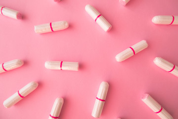 Tampons on pink background. Feminine hygiene. Flat lay