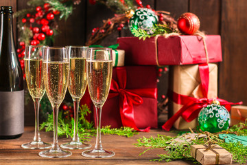 champagne and new year, christmas or noel (champagne glass, sparkling wine and gifts on the table) menu concept. food background. copy space. Top view
