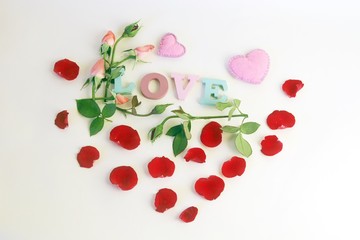 Of multi-colored letters, the word love is decorated with rosebuds, petals and hearts, a romantic greeting