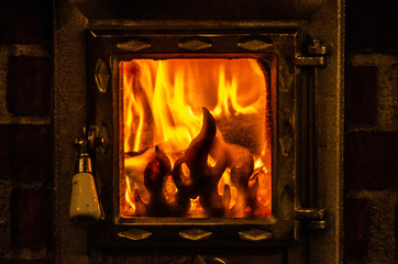 Wood burning inside the fireplace - traditional winter heating