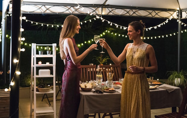 Friends drinking wine at party