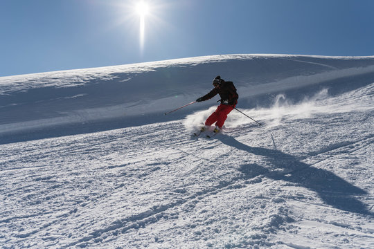 Man skiing in a bright sunny day