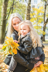 Beautiful young mother holds a little daughter in her arms