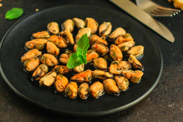 mussels in oil and spices (appetizer mollusks, pickled seafood, healthy food) menu concept. food background. copy space. Top view