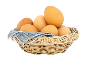 Beautiful and clean chicken eggs isolated in wicker basket with white background and clipping path.