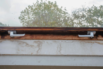 old wooden window frame with dirty mold and broken inside a old house, needs renovation