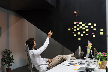 Young businessman relaxing in office