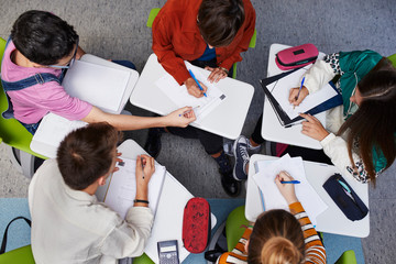 Teenage students learning with their teacher