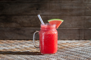 Fresh organic watermelon smoothie in glass mug on table