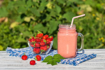 Glass of juice smoothie shake from strawberries, raspberries and banana, close up