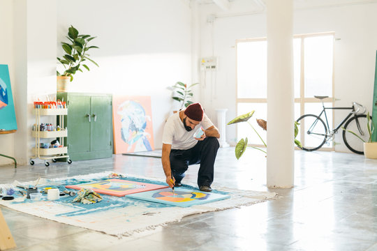 Artist painting in his studio