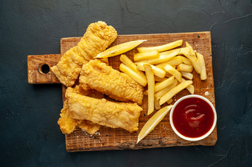 fish and chips with french fries, on a stone background  A