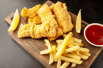 fish and chips with french fries, on a stone background  A
