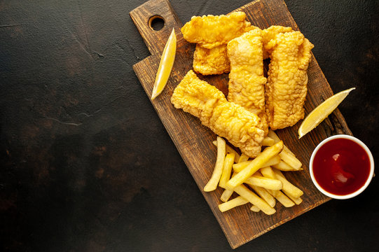 fish and chips with french fries, on a stone background