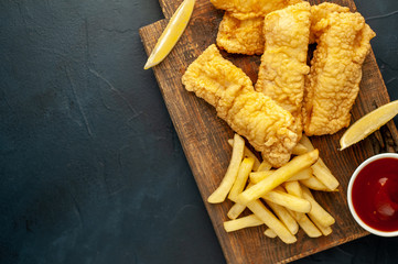 fish and chips with french fries, on a stone background