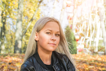 Fashion portrait young woman wearing black rock jacket in city park