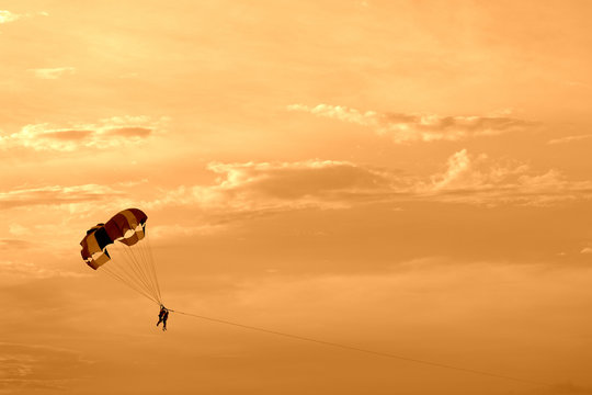 Parasailing in the evening sky near the coast of Vietnam. Orange color toned