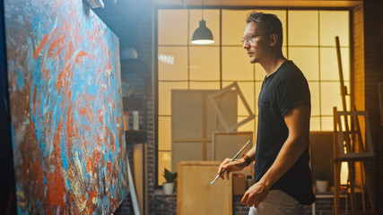 Portrait of Talented Artist Working on Abstract Painting, Uses Paint Brush To Create Daringly...