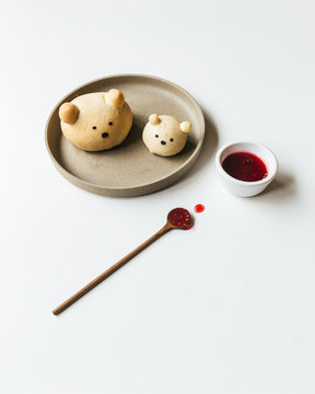 Homemade bear bread buns plated with honey and jam