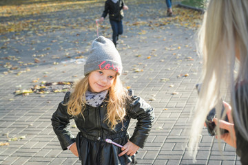 Cute Little Girl In The Autumn Park