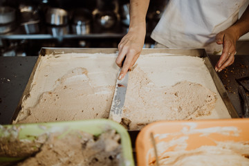 Professional confectioner working making and decorating delicious sweets. Close up shot.