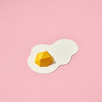Hand crafted paper fried eggs on a coral background with space for text. Breakfast concept. Pantone 16-1546 Living Coral is the color of the year 2019. Top view