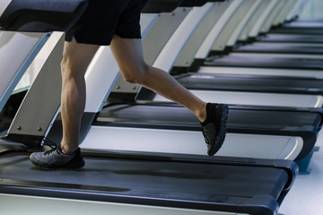 Man running on treadmill in health club