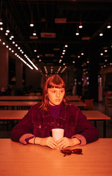 young woman sitting in a fast food