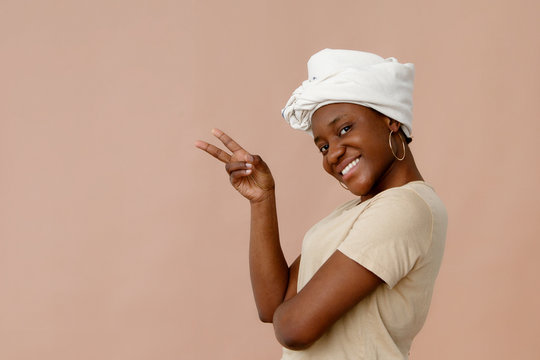 Cheerful black female gesturing V sign