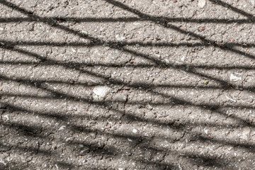 Cracked ground. Net of asphalt cracks. Gray background