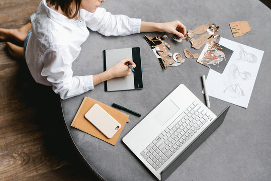 Girl with laptop and graphic tablet