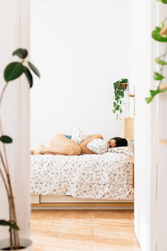 Woman lying on her bed.