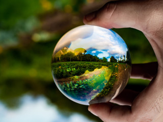 evocative countryside landscape with vegetable garden in the glass sphere