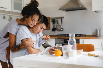 Young couple using the digital tablet together at home