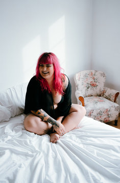 pink haired woman resting in lingerie