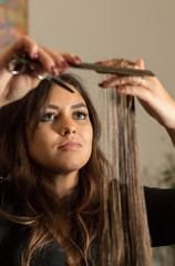 hairdresser cuts a woman's hair