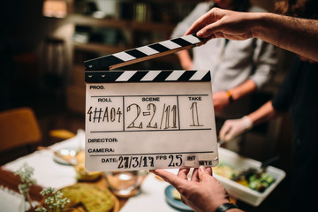 Hand Holding A Clapperboard During A Movie Recording