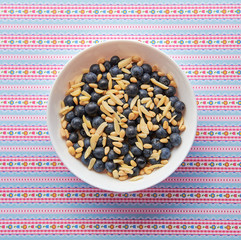 Breakfast: oatmeal with blueberries, pine nut and almonds. Pattern background