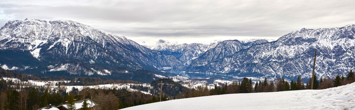 Panoramic mountain landscape of Hallstatt lake at ranny day in Austrian Alps, Salzkammergut region.